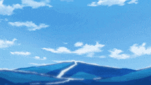 a mountain with a blue sky and white clouds