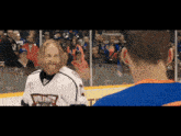 a man with a beard wears a jersey that says wolves on it