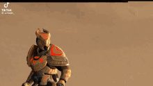 a video game character is riding a horse with a red cape on his back .
