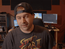 a man wearing a street fighter ii t-shirt