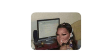 a woman wearing a headset is sitting in front of a computer monitor