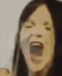 a woman is screaming with her mouth wide open .