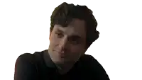a man in a black shirt is holding a glass of whiskey and smiling