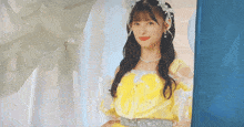 a girl in a yellow dress is standing in a room