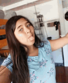 a young girl is sticking her tongue out while taking a selfie
