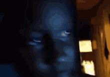 a blurry picture of a person 's face with a lamp in the background
