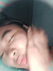 a close up of a person 's face with their eyes closed and their mouth open