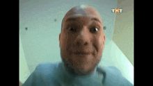 a close up of a man 's face with the letters tht on the ceiling