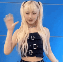 a woman with blonde hair is wearing a black crop top