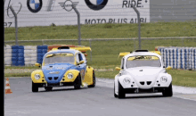two cars are racing on a track and one has a fancup sticker on the windshield