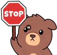 a teddy bear is holding a stop sign