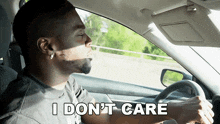a man driving a car with the words " i don 't care " on the bottom