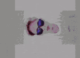 a person wearing sunglasses and a shirt that says exiled co