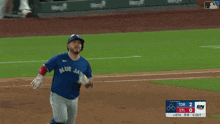 a baseball player for the blue jays is running on a field