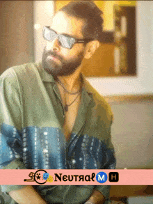 a man with a beard wearing sunglasses and a shirt that says neutral on it