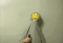 a person wearing a hoodie with a smiley face on it .