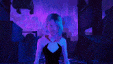 a woman with blue hair is standing in the rain with a purple background