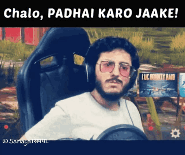 a man wearing glasses and headphones is sitting in a car with the words 
