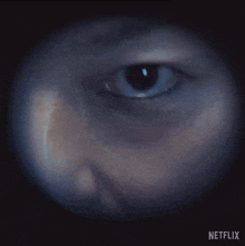 a close up of a person 's eye with netflix written on the bottom right