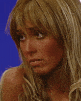 a close up of a woman 's face with a serious look on her face