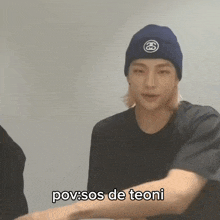 a man wearing a black shirt and a blue beanie has the words pov sos de teoni written below him