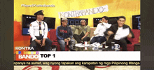 a group of people are sitting on a couch with a sign that says kontra bando top 1