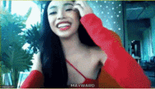 a woman in a red top with mayward written on the top