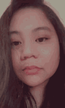 a close up of a woman 's face smiling