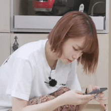 a woman wearing a white shirt that says hyper