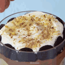 a close up of a dessert with whipped cream and nuts with mr.cakes written on the bottom right