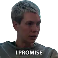 a woman says i promise while wearing a grey sweater