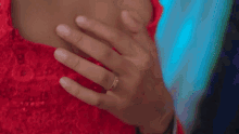 a man is hugging a woman in a red dress .