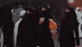 a blurry picture of a woman in a white dress and a man in a black costume .