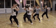 a group of young people are dancing in a dance studio and one of them has a shirt on that says ' i love you '