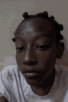 a close up of a person 's face with a serious look on her face .
