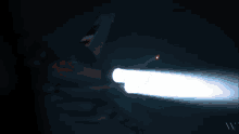 a red light shines in the dark with the letters wv visible
