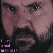 a close up of a man 's face with the words " you 're a real firecracker " above him