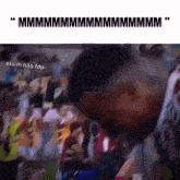 a man is standing in front of a crowd of people with a blurred image of a crowd .