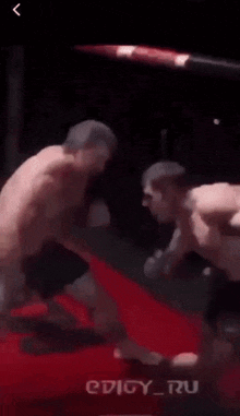a man is fighting another man in a boxing match