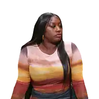 a woman with long hair is wearing a multicolored top