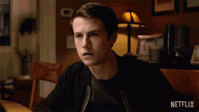a man sitting at a table with the words " why not " on the bottom right