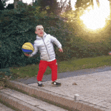 a young boy is holding a basketball that says ' nb ' on it