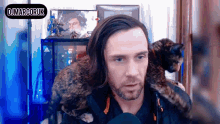 a man with a cat on his shoulder has the name dj marcoruk on the bottom