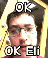 a man wearing glasses and a red shirt says ok eii