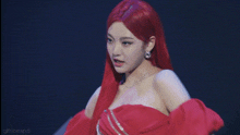 a woman with red hair is dancing in a red dress