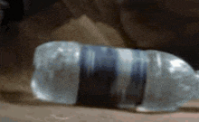 a clear plastic bottle with a black and white stripe on it
