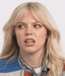 a close up of a woman 's face with a harley davidson jacket on her collar