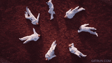 a group of people are laying in a circle with the website gifrun.com in the corner