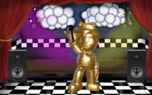 a gold statue of a bear holding a microphone on a stage