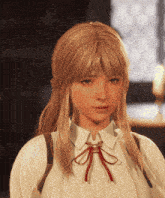 a woman with blonde hair and a white shirt has a red bow on her tie